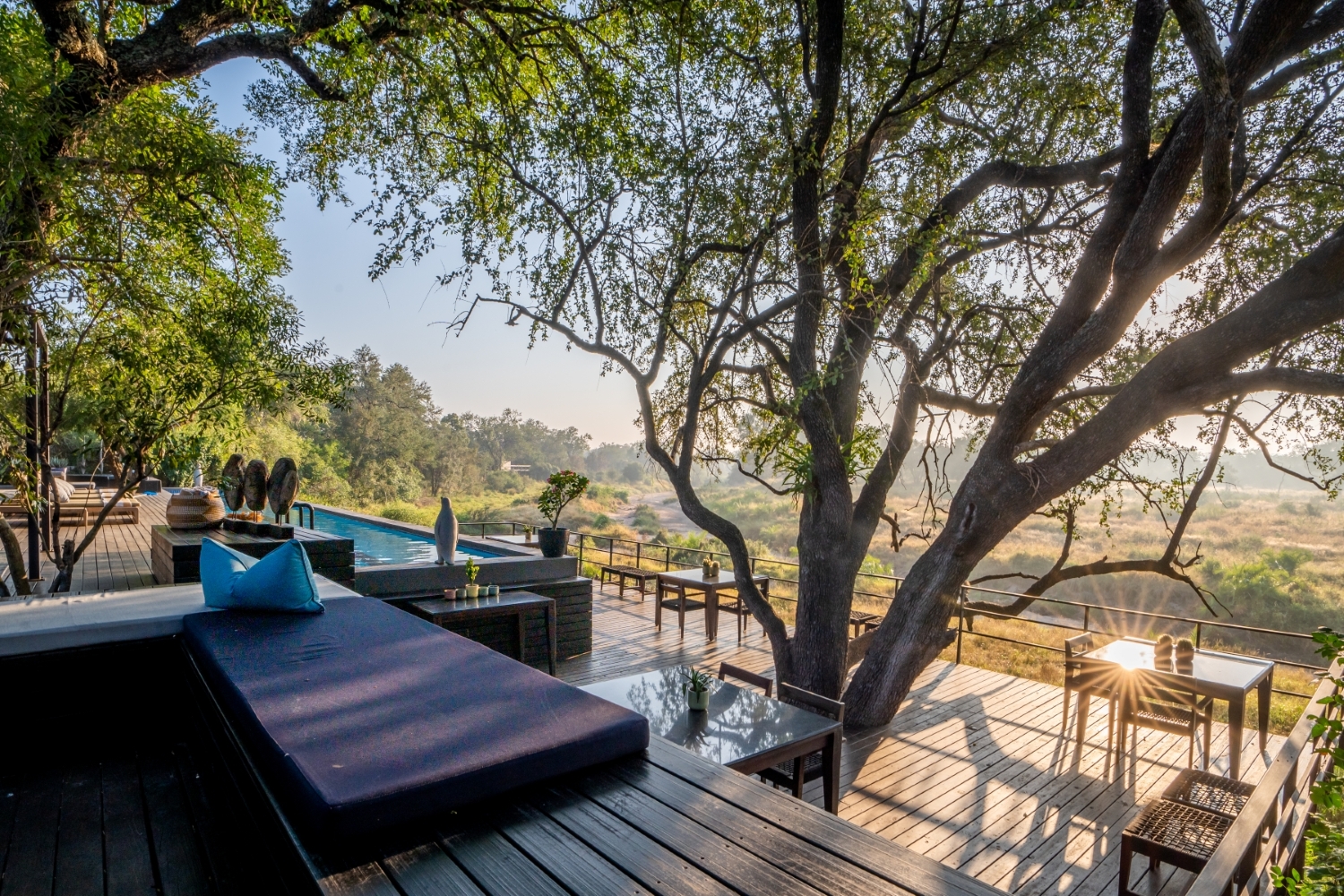 deck-loungers-and-trees-overlooking-a-sunlit-bushveld-valley.jpg